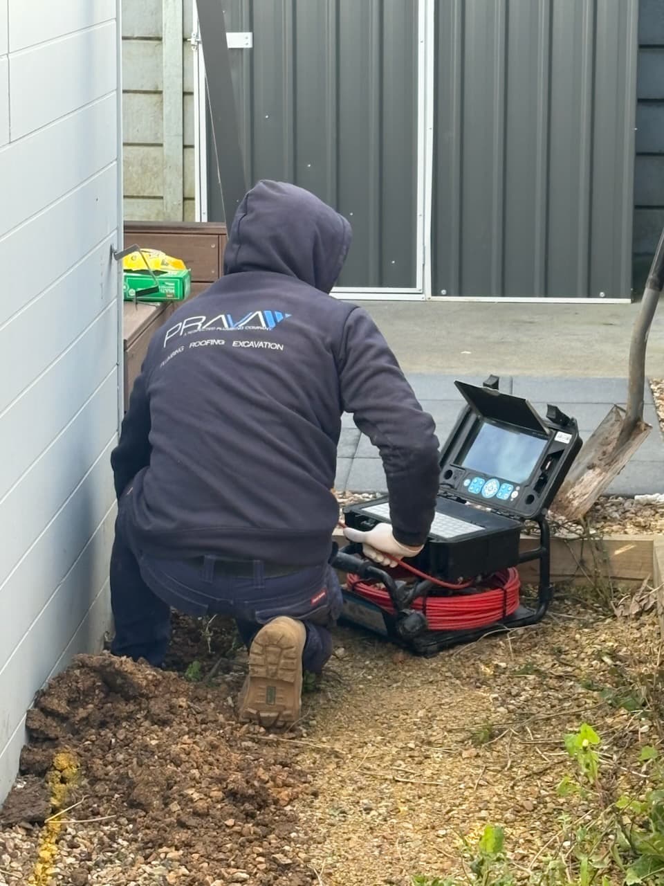Prava technician operating a CCTV drain locating control panel
