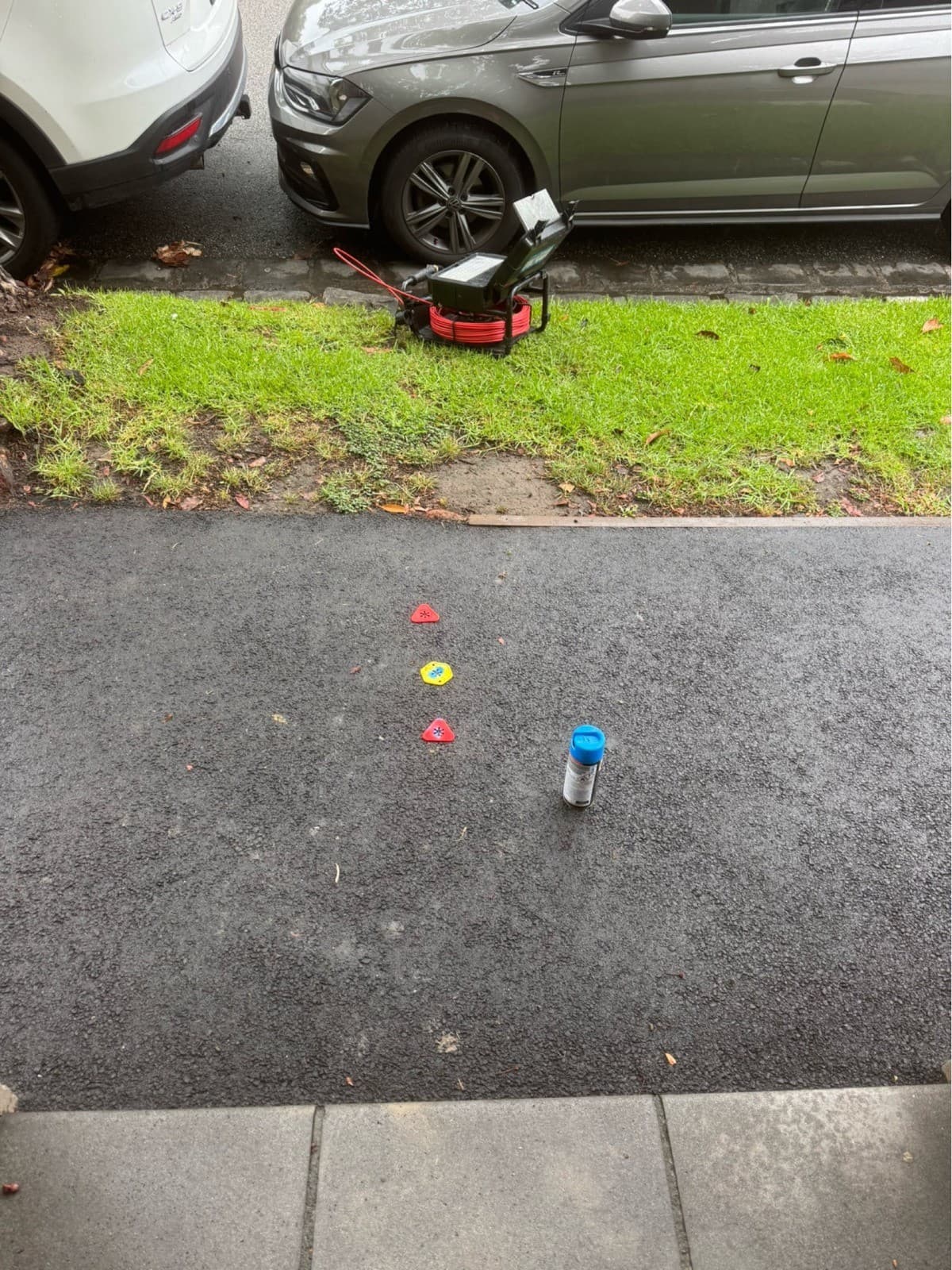 Underground service locate markings on a driveway