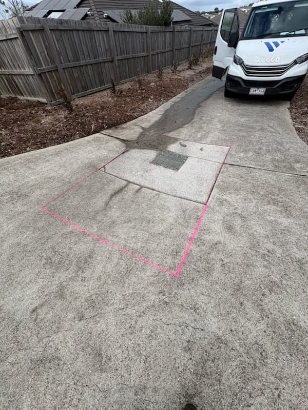 Underground service locate markout on a concrete driveway